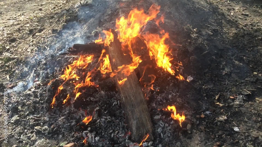 wooden planks burning in huge bonfire on the charcoal heap wooden planks burning in huge bonfire on the charcoal heap