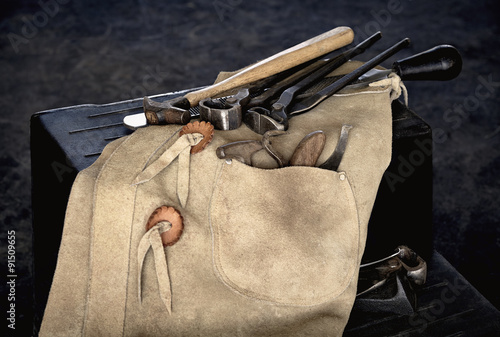 Farrier Tools with Chaps on Stool photo