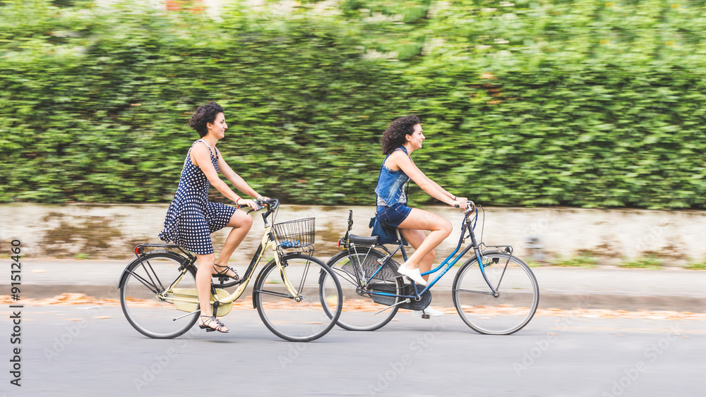 Fototapeta premium A couple of friends with bikes, motion blur.