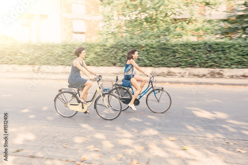 A couple of friends with bikes, motion blur.