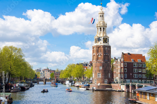 Amsterdam cityscape and the Montelbaanstoren tower on the left. The canal Oudeschans, the Netherlands.