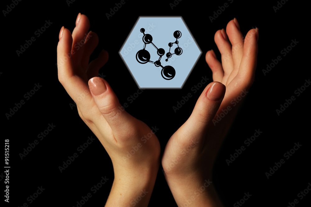 Hands with atom image, on black background Hands with atom image, on black background