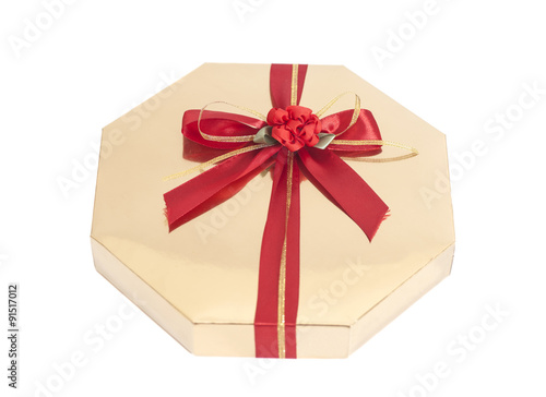 Golden gift box with red ribbon bow