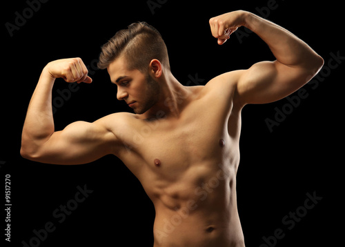 Muscle young man on dark background