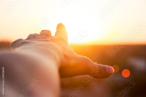 hand reaches for the sun