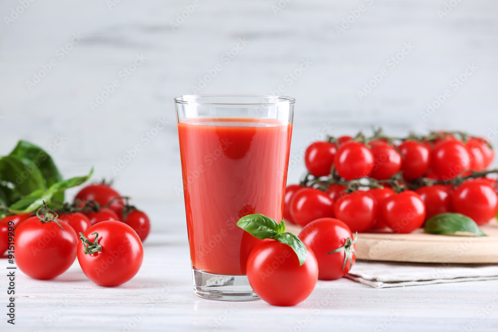 Glass of tomato juice with vegetables on wooden table close up Glass of tomato juice with vegetables on wooden table close up