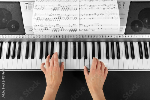 Woman playing synthesizer c...