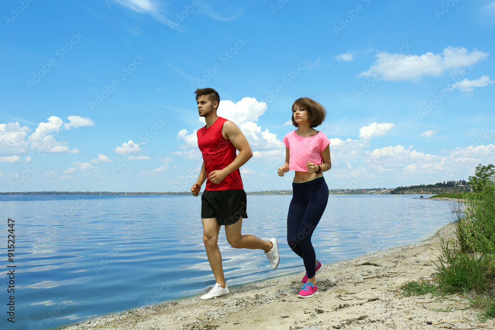 Young people jogging on beach