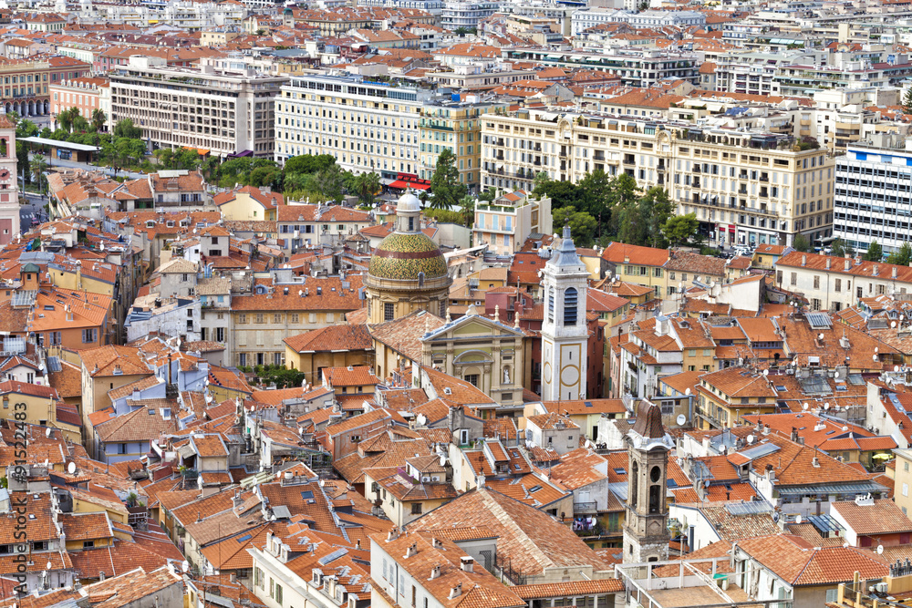 Daytime cityscape of historic Nice in French Riviera with red roofs of the old town, churches and parks