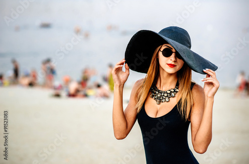 Young pretty women on the beach in black swimwear © bedya
