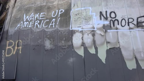 Graffiti messages left on the burned out rubble of Ferguson Missouri urge America to wake up. photo