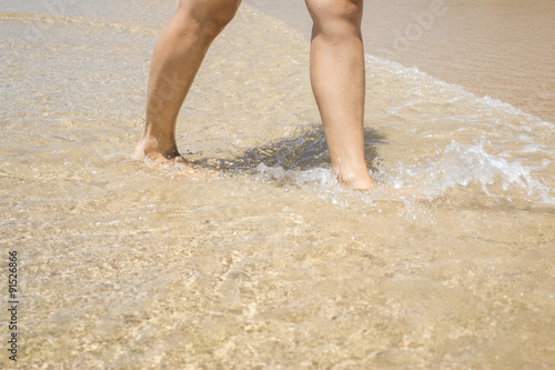 Woman legs on the beach