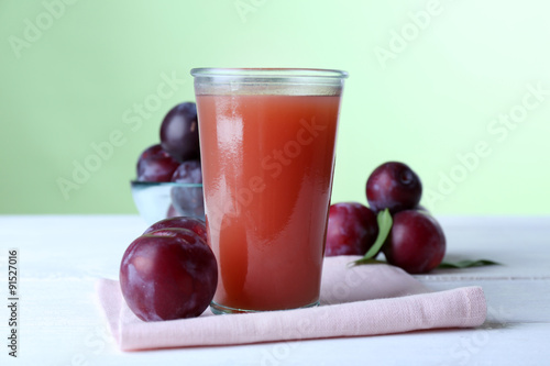 Wallpaper Mural Delicious plum juice with fruits on green background Torontodigital.ca