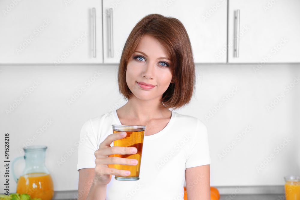 Young beautiful woman showing glass of apple juice Young beautiful woman showing glass of apple juice
