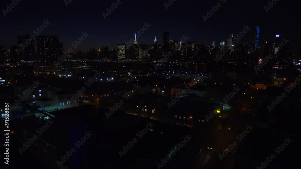A wide angle view over Queens, New York City at dusk with the Manhattan skyline background. A wide angle view over Queens, New York City at dusk with the Manhattan skyline background.