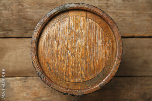 Old wine barrel on wooden background