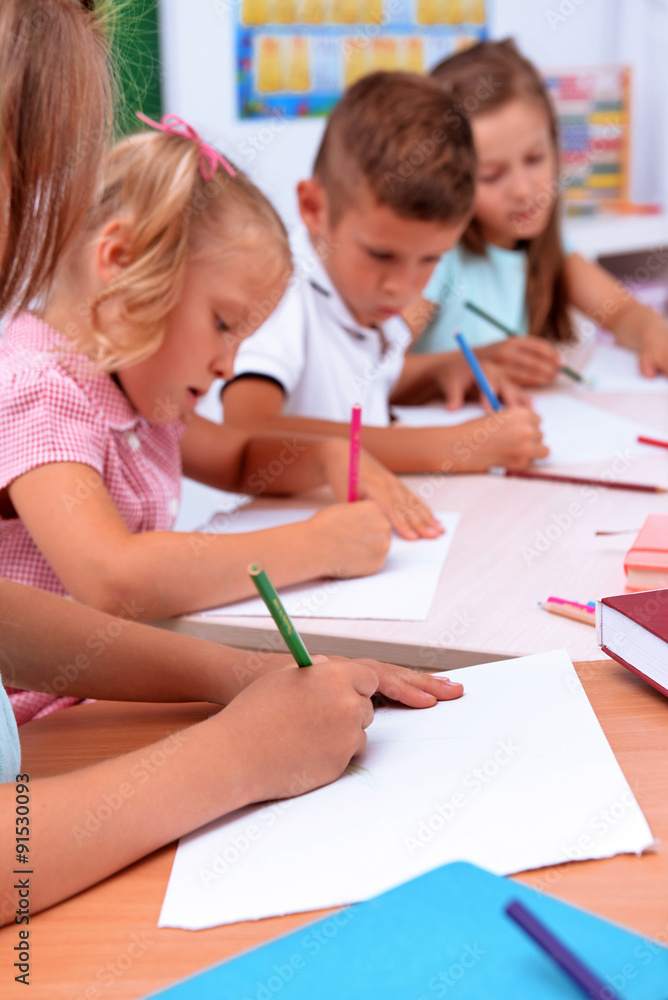 Group of children drawing at the desk, closeup Group of children drawing at the desk, closeup
