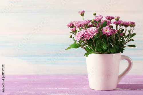 Beautiful purple chrysanthemum flowers on wooden background