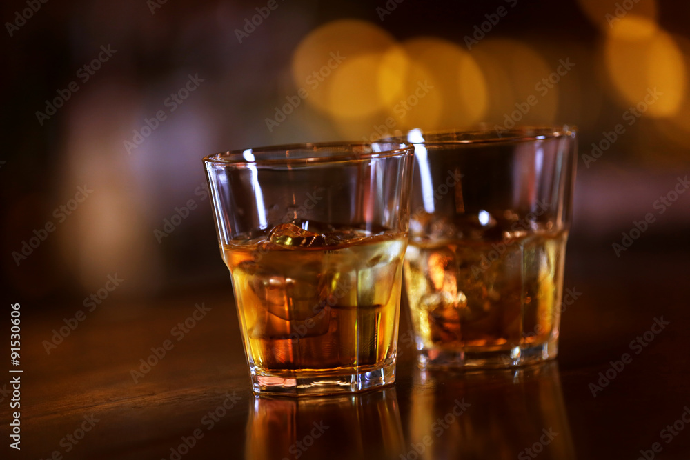Whiskey glass tumbler standing on bar counter Whiskey glass tumbler standing on bar counter