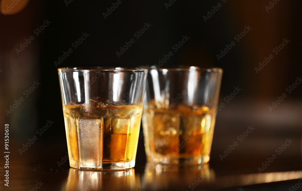 Whiskey glass tumbler standing on bar counter Whiskey glass tumbler standing on bar counter