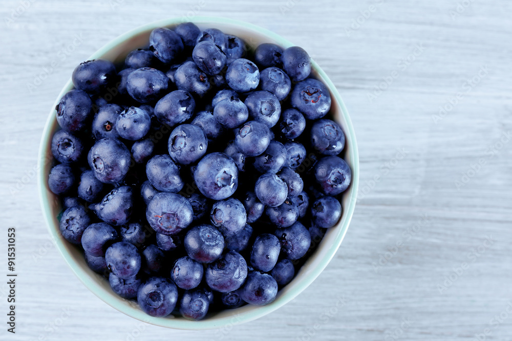 Fresh blueberries in bowl on table close up Fresh blueberries in bowl on table close up