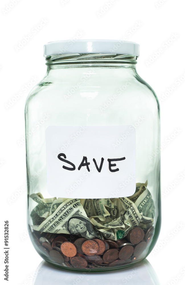 Glass jar with with a white save label and some money in it Glass jar with with a white save label and some money in it