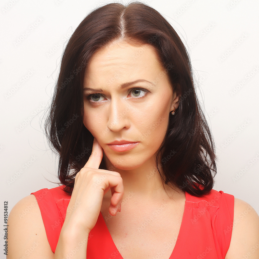 Fototapeta premium Thinking woman. Studio shot.