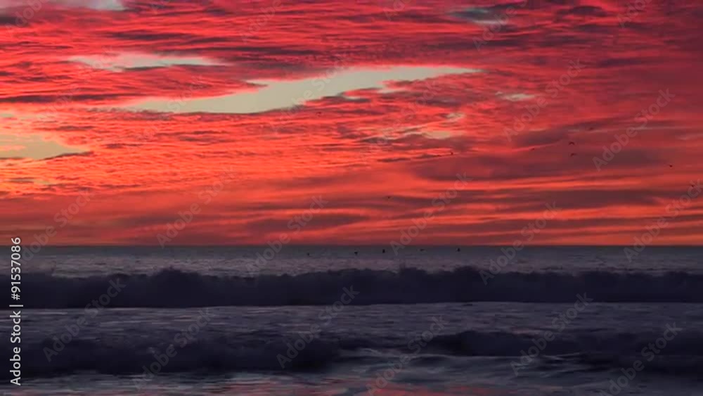 Zoom back from a blood red sunset reveals the California ocean. Zoom back from a blood red sunset reveals the California ocean.