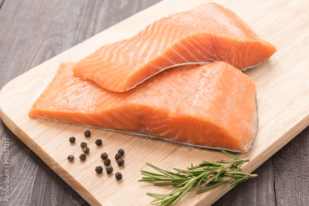 Fresh salmon and pepper on the wooden table Fresh salmon and pepper on the wooden table