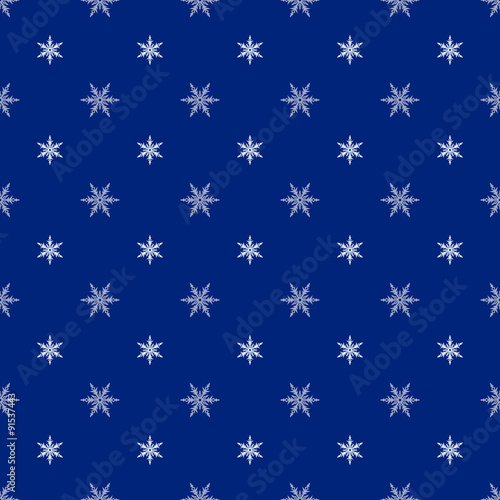 Christmas seamless pattern with snowflakes on a navy blue backgr