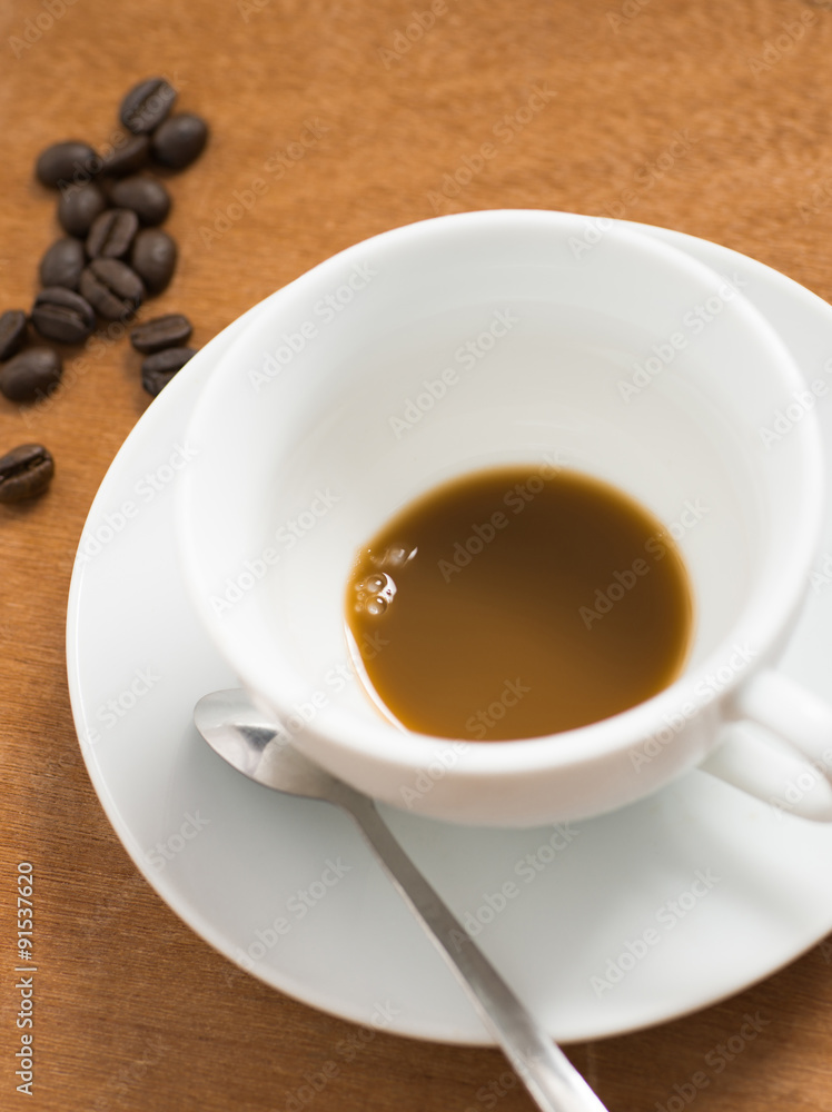 Empty white cup of hot coffee latte on wooden table Empty white cup of hot coffee latte on wooden table