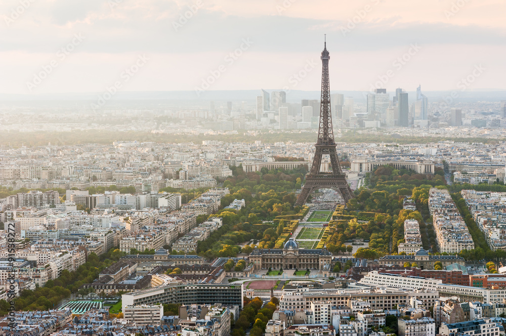 Paris skyline with the Eiffel tower and La Defense business district in the haze in the background, France