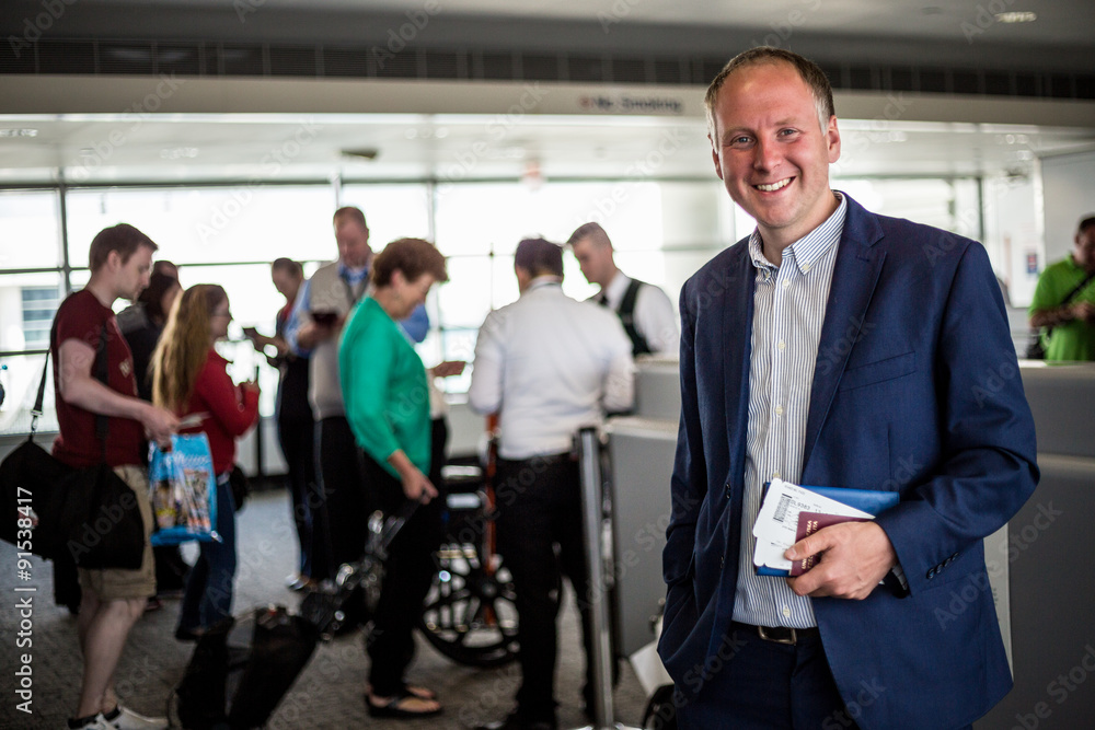 Businessman with passport and boarding pass at the airport