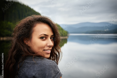 Smiling female near the lake