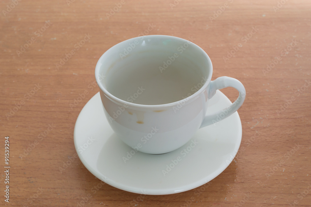 Coffee cup with stains on wood background Coffee cup with stains on wood background