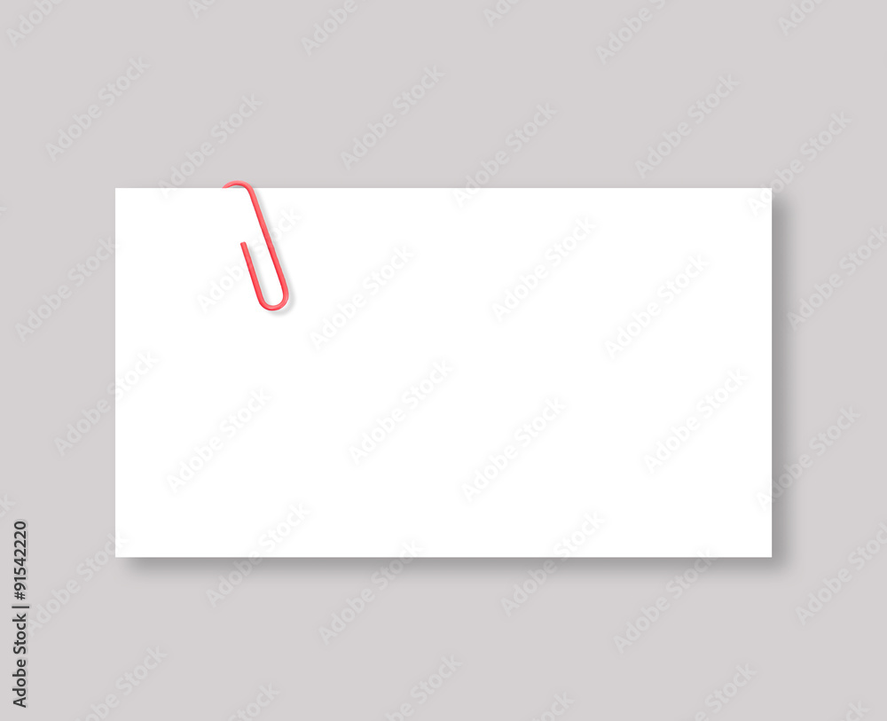 White blank space and red paper clip on grey background White blank space and red paper clip on grey background