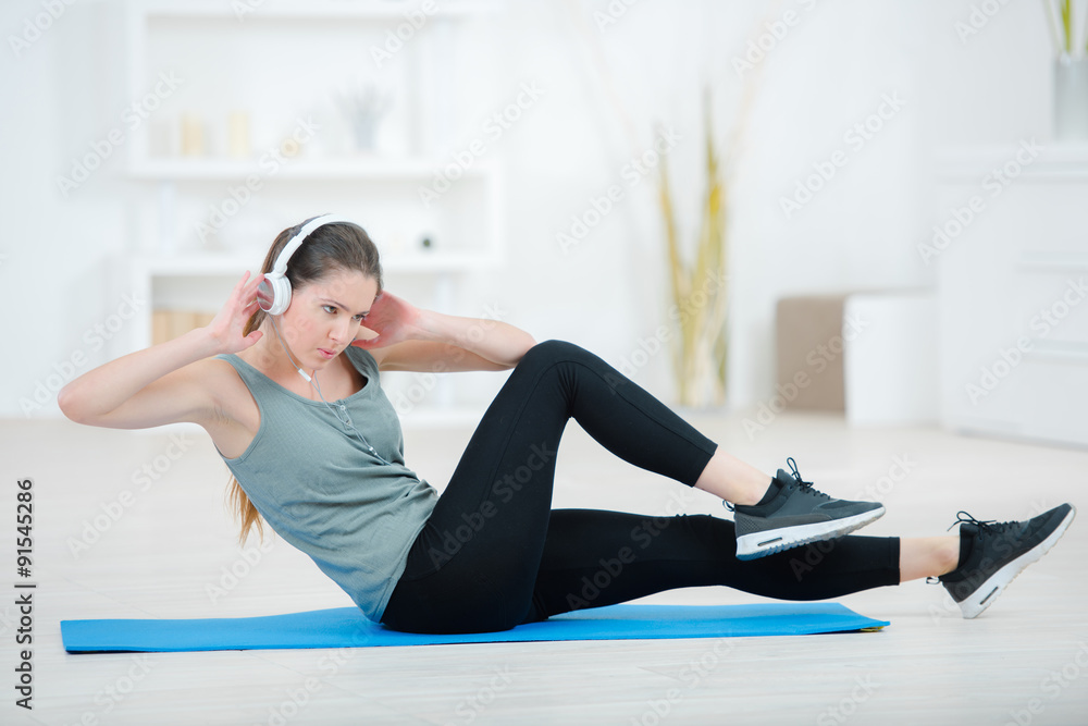 Fototapeta premium Lady exercising wearing headphones