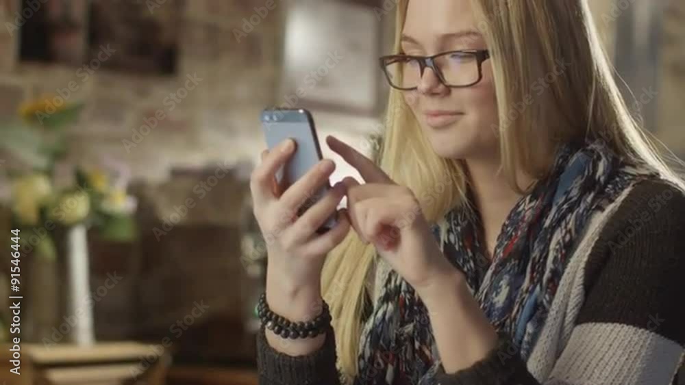 Girl Using Phone in Coffee Shop Girl Using Phone in Coffee Shop