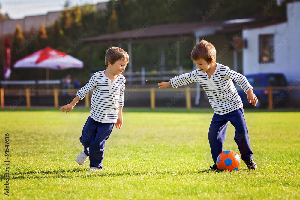 Obraz premium Two cute little boys, playing football