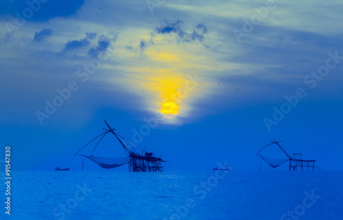 Fisherman silhouette at night.