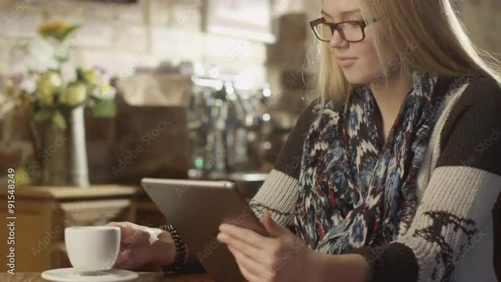 Pretty Girl Typing on Tablet PC in Coffee Shop Pretty Girl Typing on Tablet PC in Coffee Shop