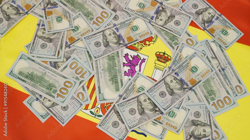 flag of Spain and lots of hundred dollar bills flag of Spain and lots of hundred dollar bills