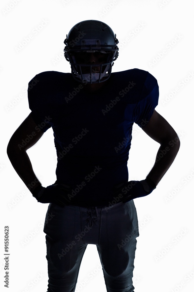 Silhouette American football player standing with hand on hip Silhouette American football player standing with hand on hip