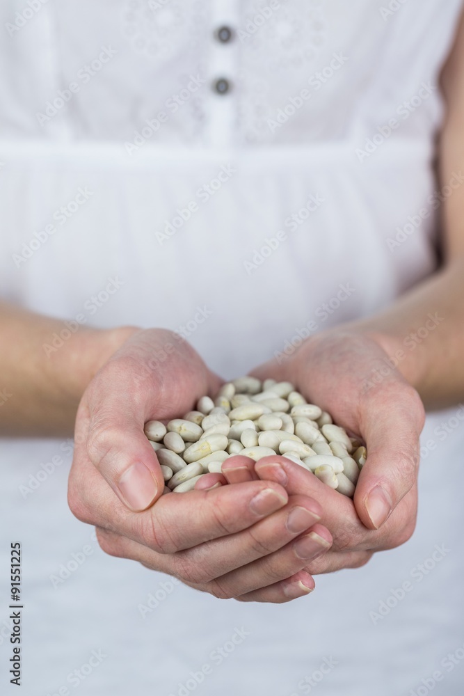 Woman showing handful of lima beans Woman showing handful of lima beans