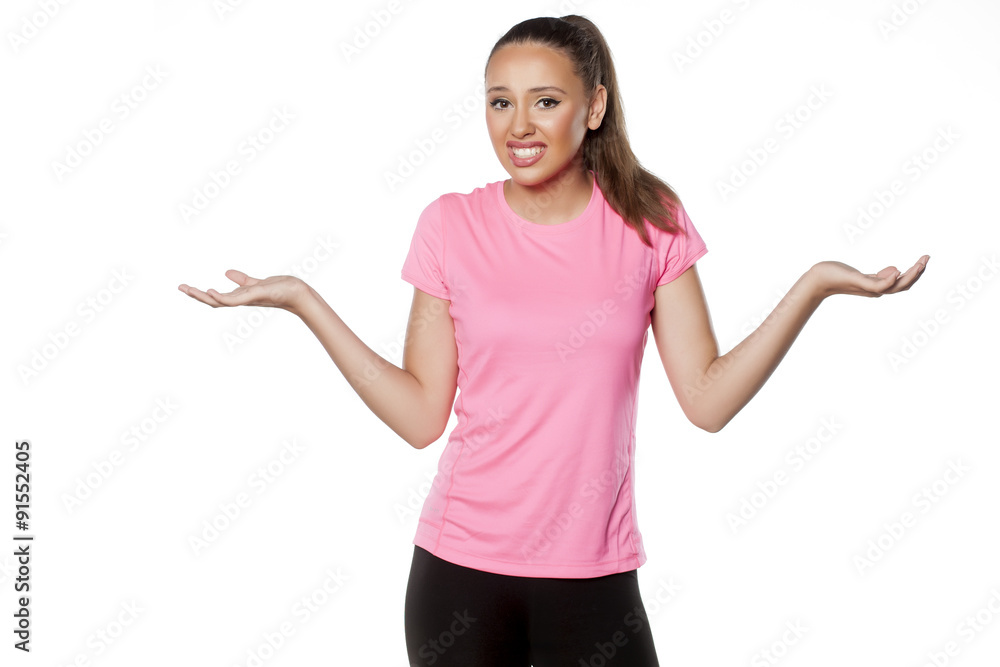 confused beautiful young athlete on a white background confused beautiful young athlete on a white background
