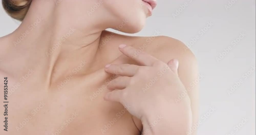 Beauty portrait of woman touching healthy skin in slow motion skincare concept on a grey background Red Epic Dragon Beauty portrait of woman touching healthy skin in slow motion skincare concept on a grey background Red Epic Dragon