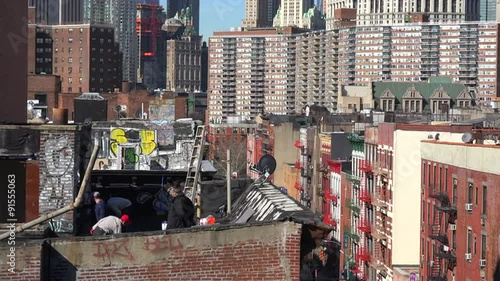 A rooftop view looking across the financial district of New York city to One World Trade Center.