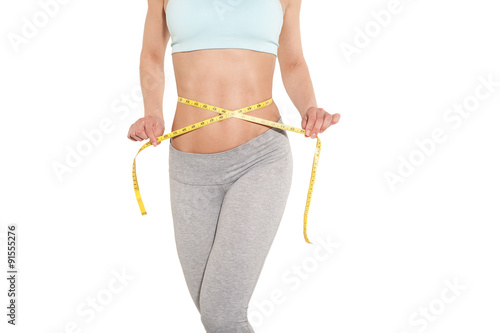 weight loss, sports girl measuring her waist, training in the gym, workout abdominals