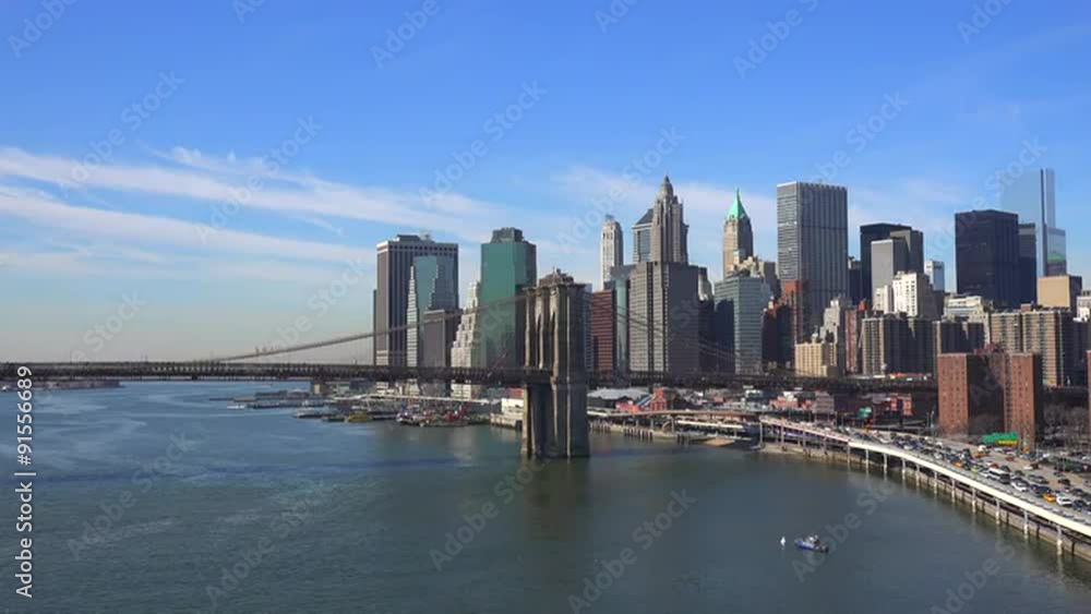 The Brooklyn Bridge, East River and FDR parkway on a clear sunny day in New York City. The Brooklyn Bridge, East River and FDR parkway on a clear sunny day in New York City.