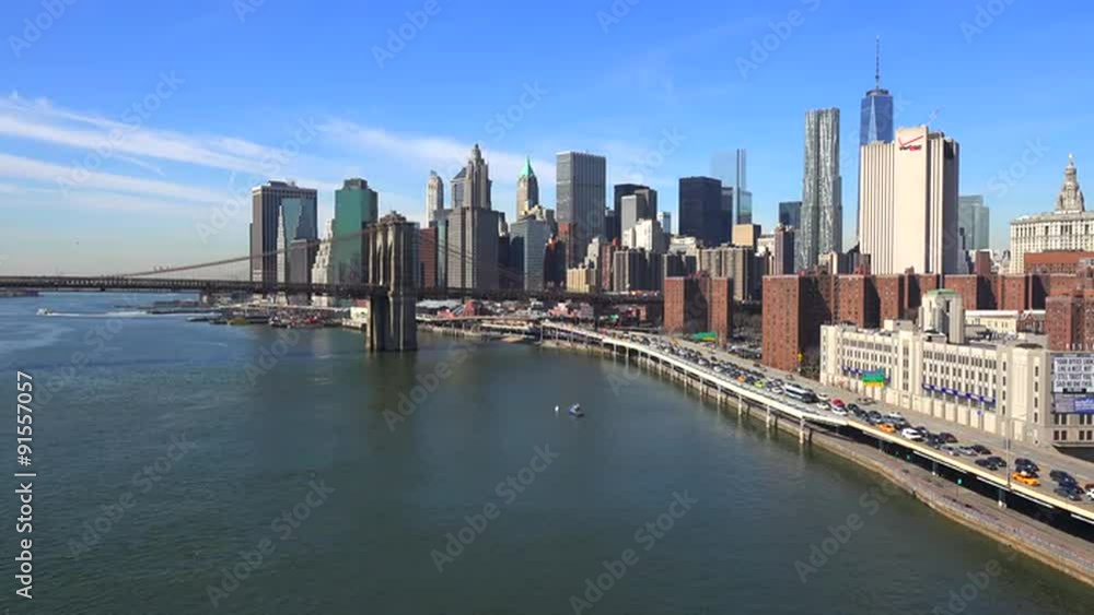 The Brooklyn Bridge, East River and FDR parkway on a clear sunny day in New York City. The Brooklyn Bridge, East River and FDR parkway on a clear sunny day in New York City.
